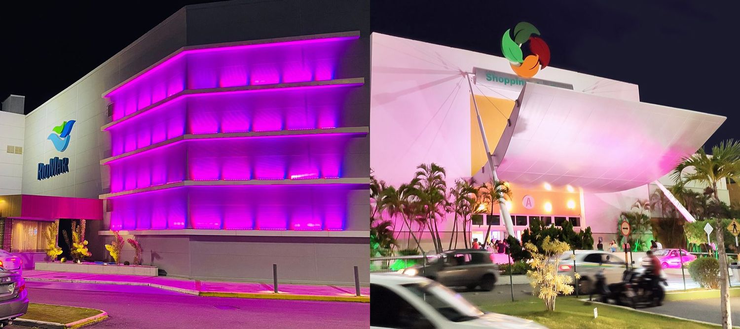 Imagem dos shoppings Jardins e RioMar Aracaju com suas fachadas iluminadas de rosa em adesão ao movimento Outubro Rosa